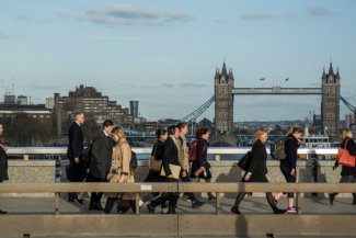 Commuters walking over London Bridge