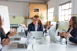 Business people around a meeting table