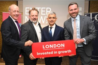 Sadiq Khan and colleagues at MIPIM 2025 holding a sign saying 'London - Invested in Growth'