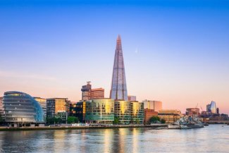 Queens walk on the south bank of River Thames at sunset in London. England