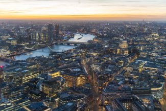 A stunning sunset over London, casting warm hues on the skyline and highlighting famous landmarks.