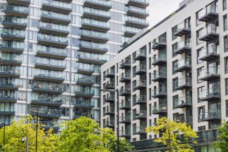 Housing development.  A spacious building with an abundance of windows, reflecting a contemporary style.