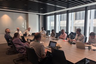 BusinessLDN-Delotte Steering Group - Several individuals gathered at a table, participating in a conversation.