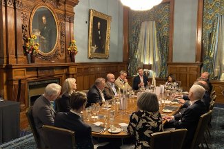 A group of individuals engaged in business dinner discussion