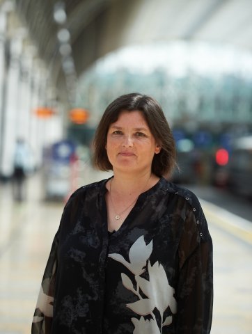 Lady with short hair and black top 