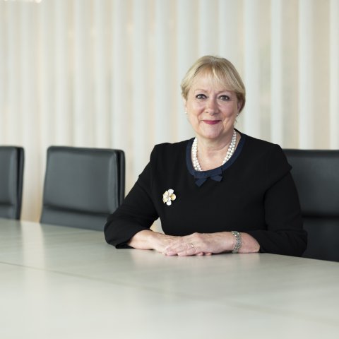 Helen Gordon Headshot. Blonde woman wearing black top