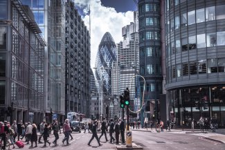City of London street with buses and people passing by, business and banking district with modern skyscrapers