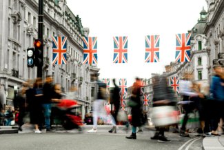 Motion blurred crowds of people on busy London shopping street