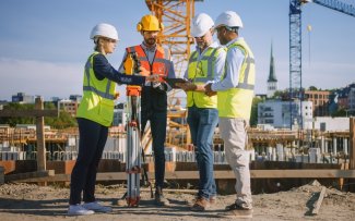 People on a construction site discussing plans