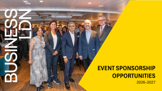 A professional setting showcasing a London business event with banners highlighting sponsorship opportunities.