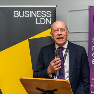 Deputy Mayor Jules Pipe CBE delivers a speech at the BusinessLDN London Social at UKREiiF, engaging the audience with his presentation