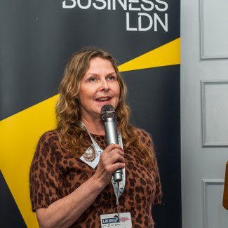 Karen Alcock of Kanda delivers a speech at the BusinessLDN London Social at UKREiiF, engaging the audience with his presentation
